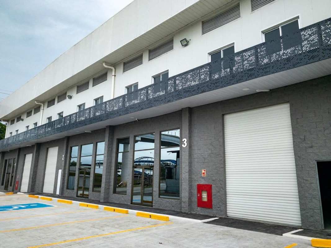 Modern industrial warehouse exterior multiple parking loading bays Via Tocumen Panama