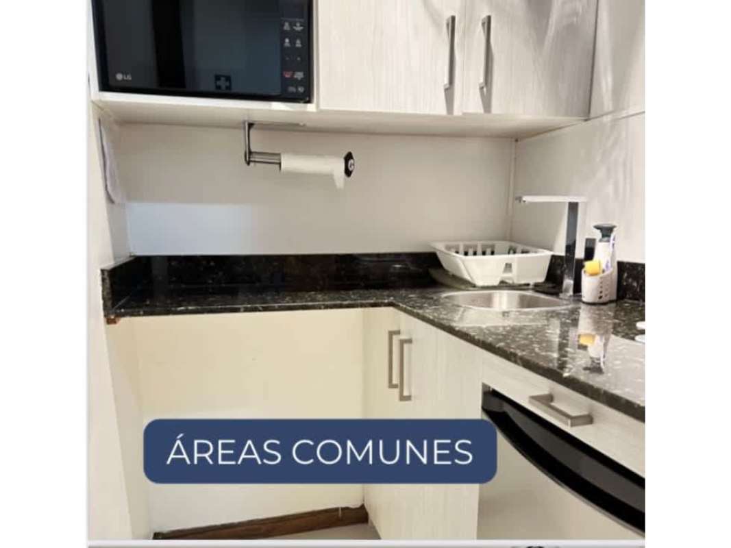 Modern kitchenette with granite countertop, cabinets, microwave in Oceania Business Plaza office Panama City