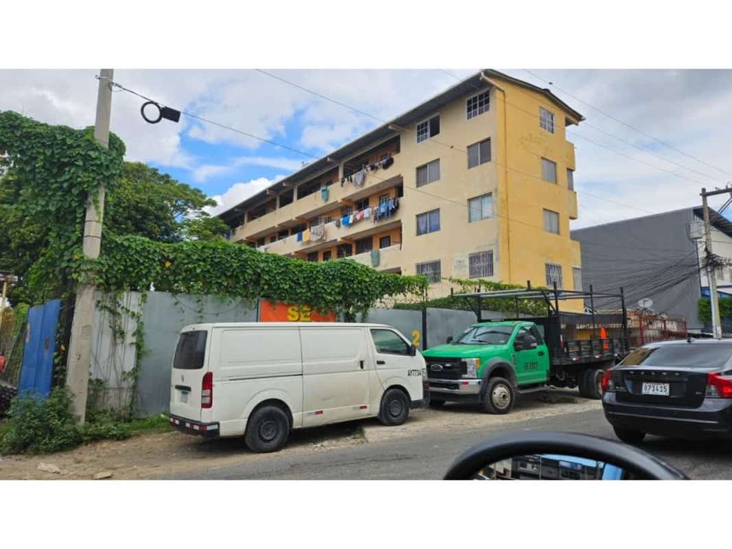 Vacant urban land with mature trees neighboring buildings Parque Lefevre Panama