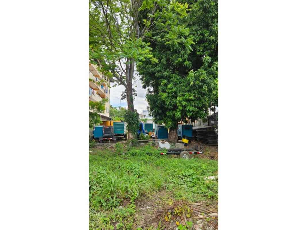 Multi-story yellow apartment building adjacent fenced lot in Parque Lefevre Panama