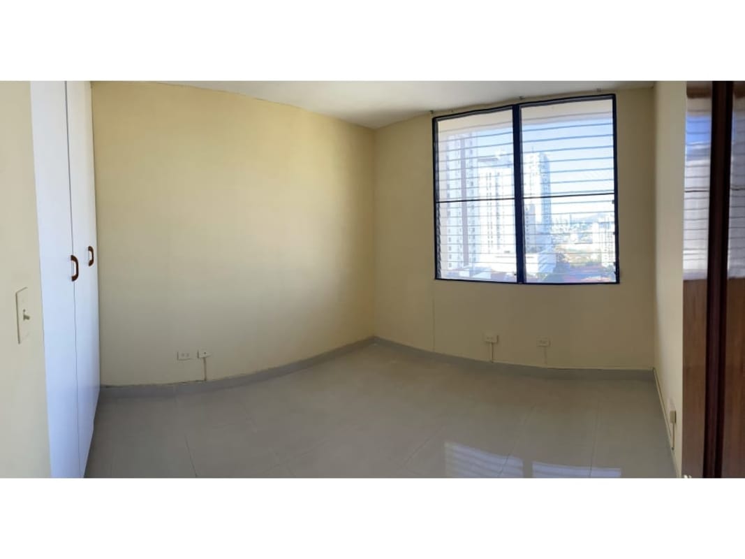 Bedroom with built-in closet tile floor and skyline view in PH Torres del Sol Panama City