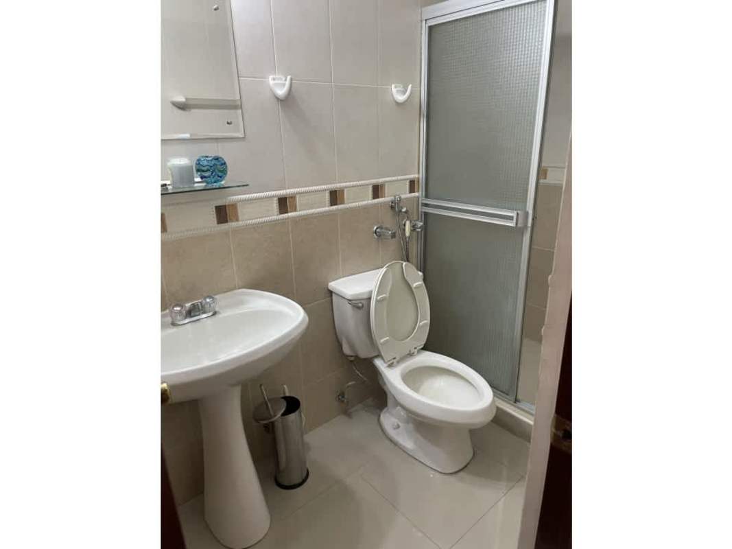 Compact bathroom with glass shower, pedestal sink, modern fixtures in PH Torres del Sol