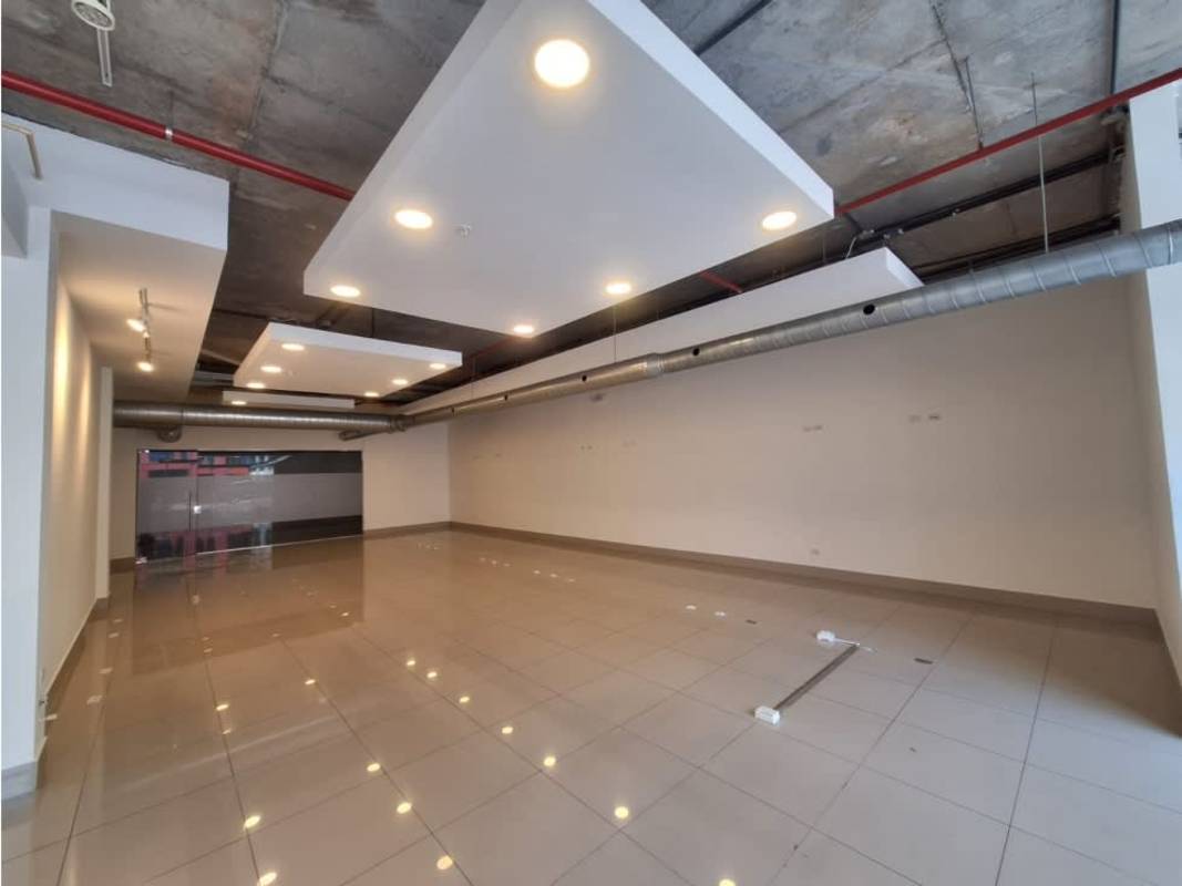 Spacious empty unit with industrial ceiling and large storefront windows at Habitats Plaza Panama City Panama