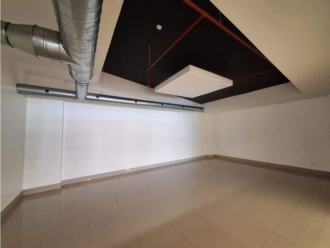 Large commercial interior with tiled floors and exposed ceilings at Habitats Plaza Panama City Panama