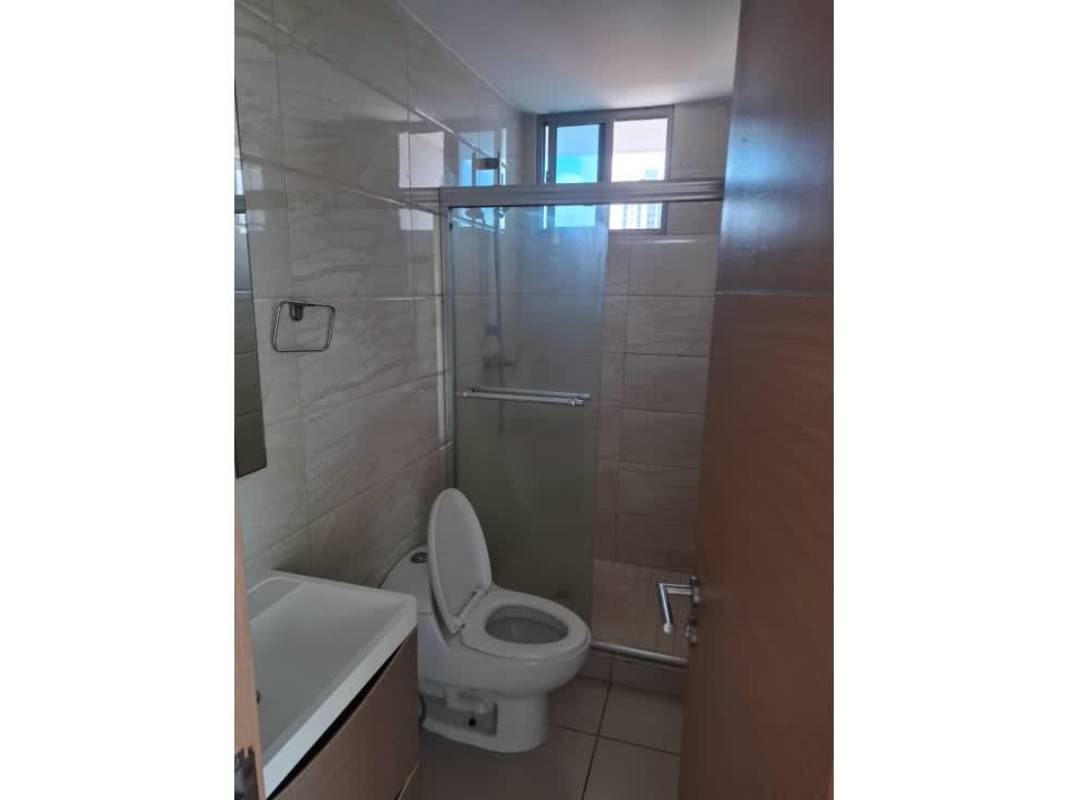 Bathroom with glass shower enclosure, vanity sink, and beige tiles at PH Torres de Castilla