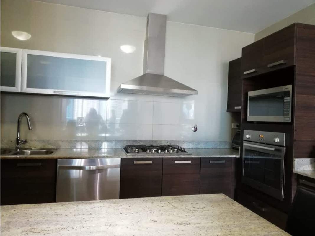 Contemporary kitchen with stainless steel appliances and granite at Grand Tower Punta Pacífica Panama