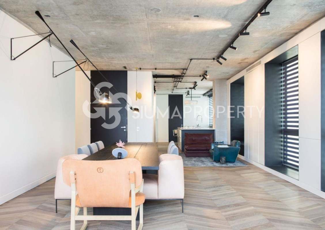 Industrial modern open living-dining space with large windows in PH Coco del Mar penthouse Panama