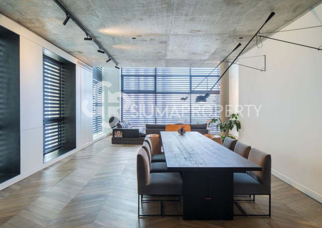 Modern industrial dining room with chevron wood floor large windows PH Coco del Mar penthouse Panama