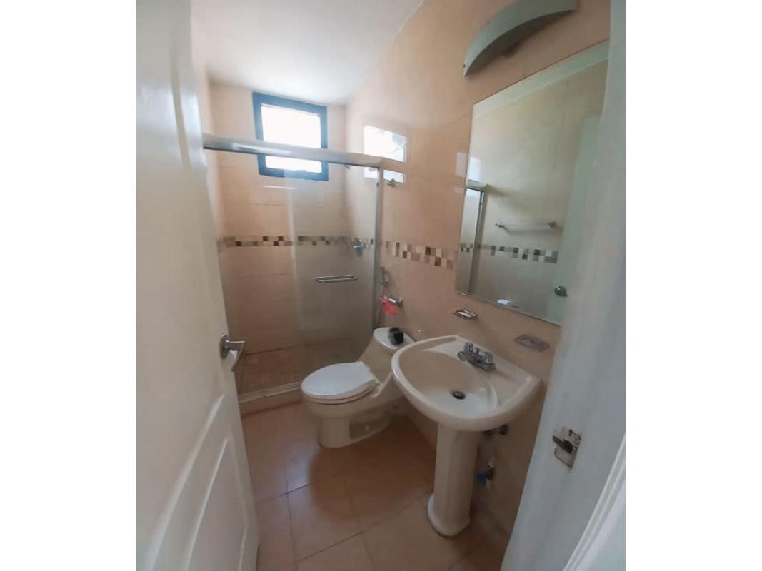 Modern bathroom with glass-enclosed shower, vanity, and ceramic tiling PH San Francisco Bay