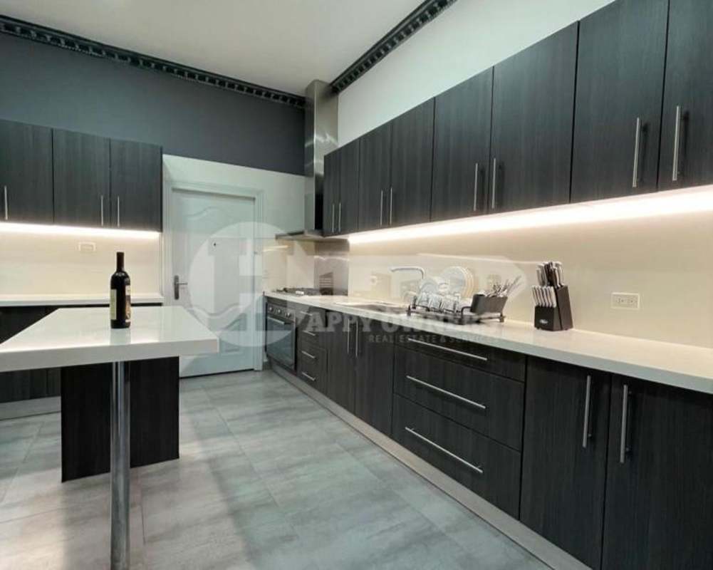 Bright bedroom with gray upholstered bed, AC, tile flooring and accent wall at PH Vista Magna Altos de Panamá