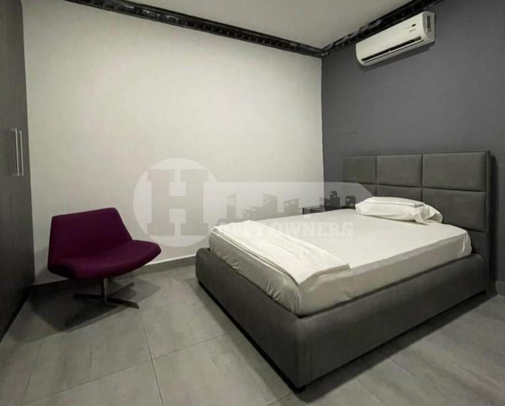 Modern bedroom with padded headboard, AC, tile floor, wall accents PH Vista Magna Altos de Panamá