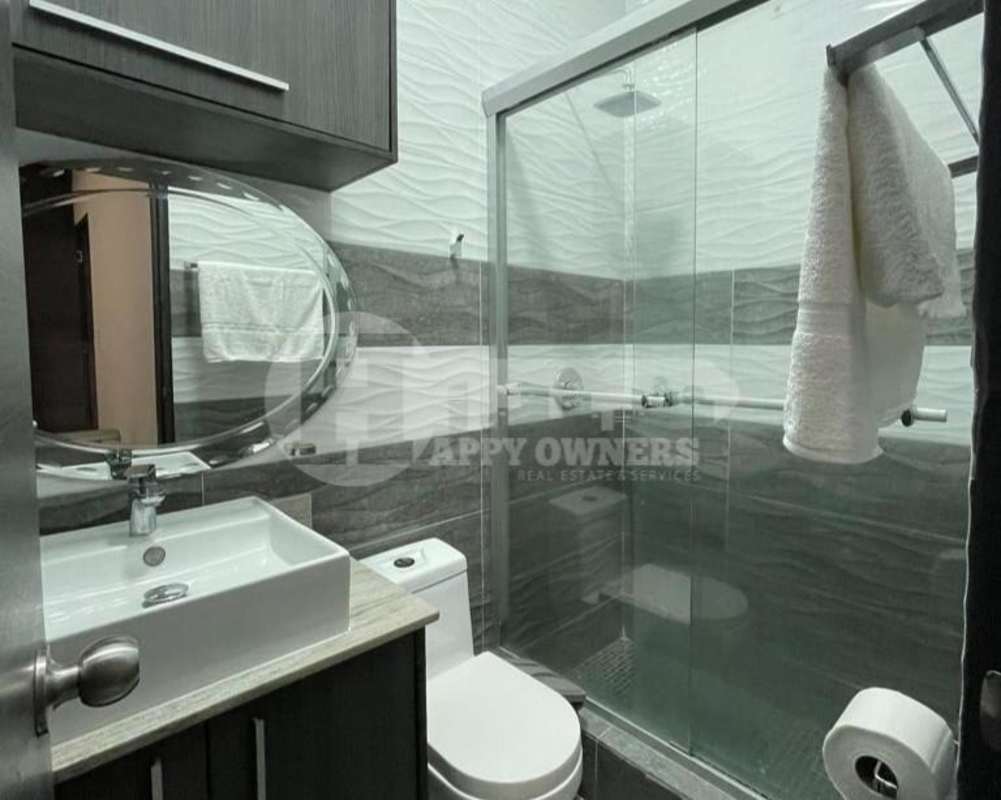 Contemporary bathroom with glass-enclosed shower, modern sink and tile accents at PH Vista Magna