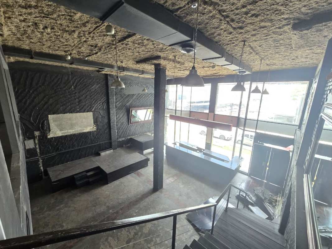 Two-level commercial space with mezzanine, modern staircase and glass railings for rent in Obarrio Panama City