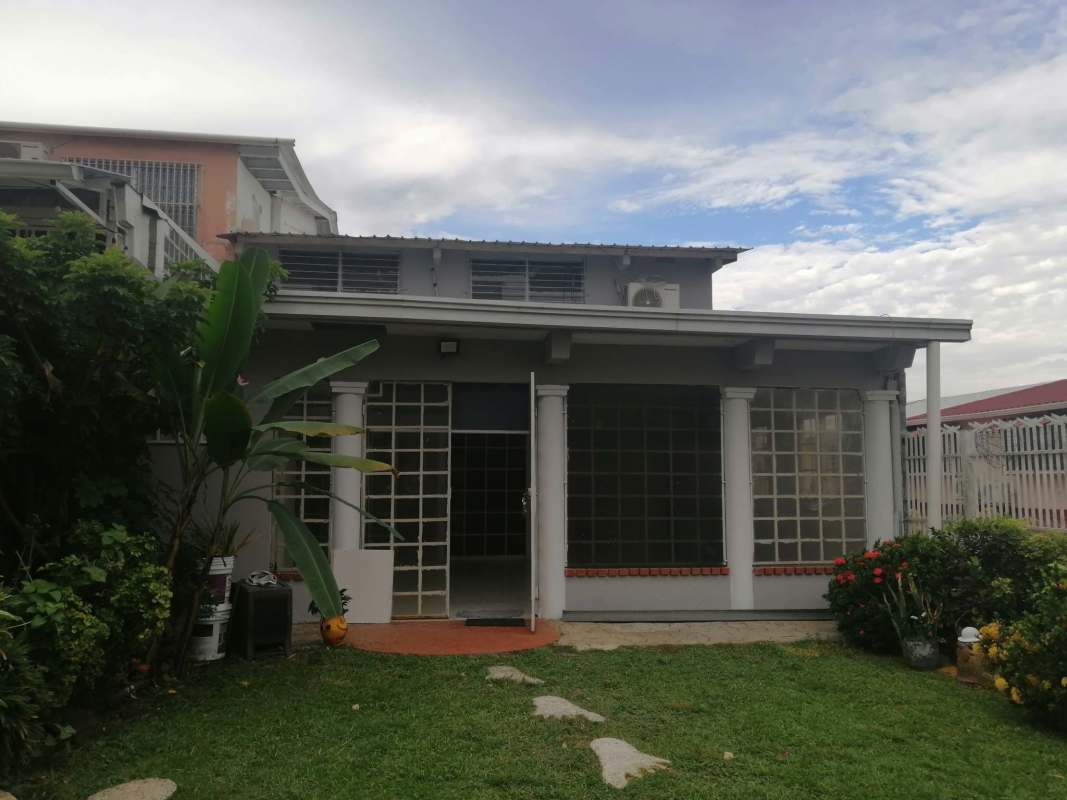 Modern kitchen with granite countertops, light wood cabinetry in Betania Panama house