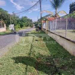 Gated community street view in Bahia Serena Coronado with fence and paved road