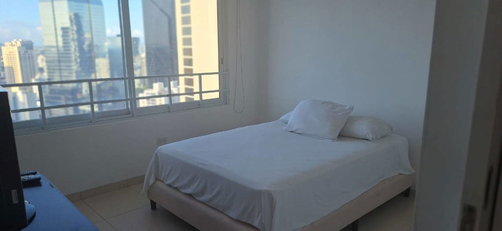 Spacious master bedroom with panoramic window city skyline view PH Villa del Mar Panama City