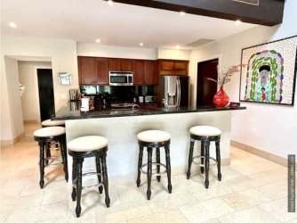 Modern kitchen with granite countertops wood cabinetry Buenaventura Casa Bristol villa Panama