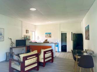 Living, dining, kitchen combined room with tile floors wooden furniture home Panama