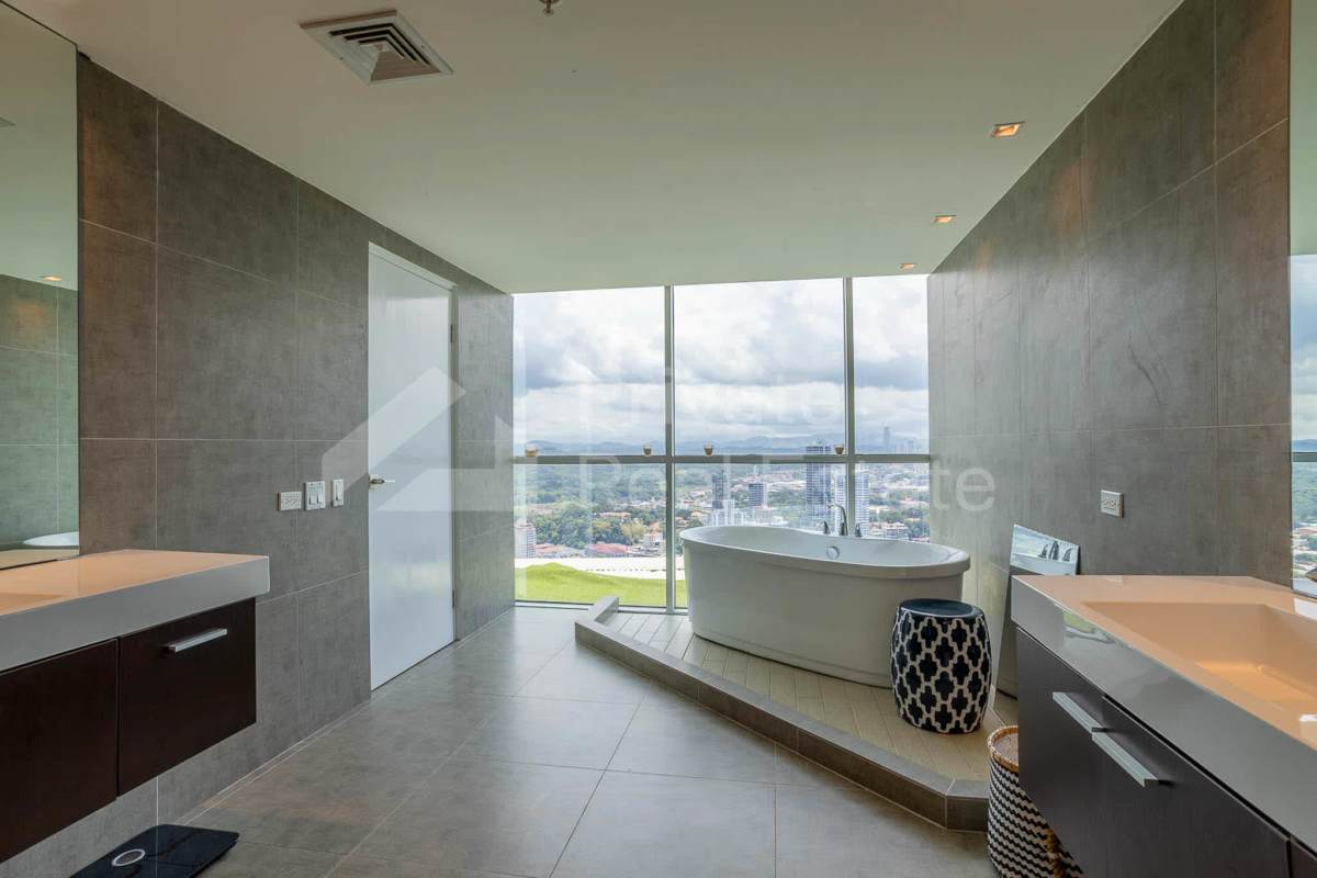 Open contemporary kitchen with granite countertops and appliances in Yacht Club Tower Panama City apartment