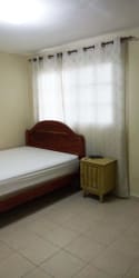 Furnished bedroom with window curtains, bed and tile floors in Arraijan rental