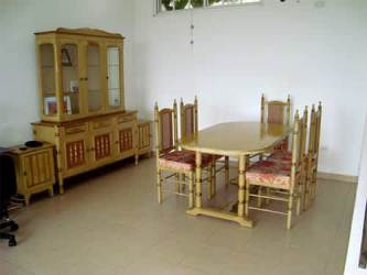 Traditional dining space with window and furniture in furnished rental Panama Oeste