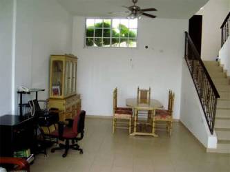 Minimalist living dining area with ceiling fan, office corner and window in Panama Oeste rental