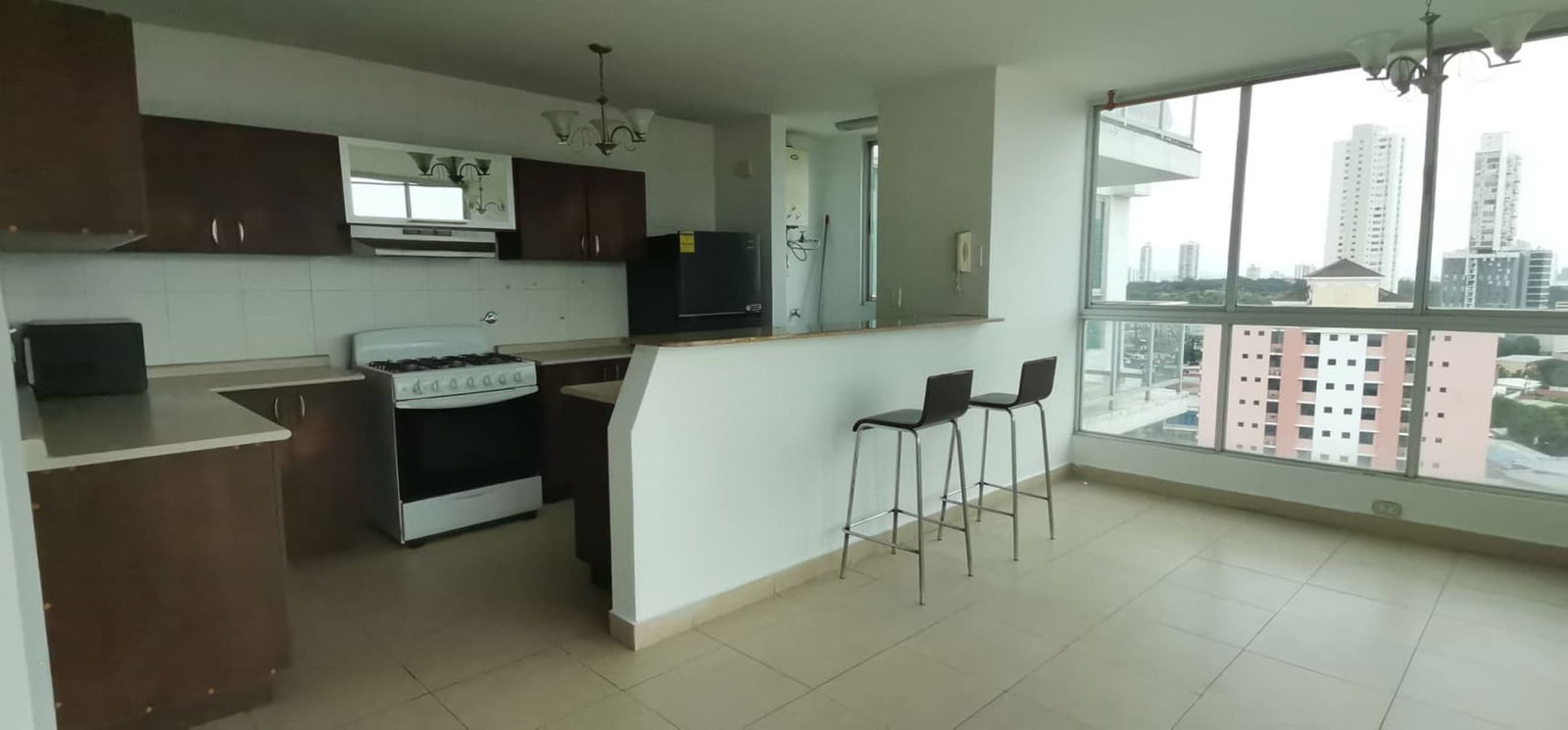 Modern open-plan kitchen dining with breakfast bar city view PH Oasis Tower Via Porras Panama