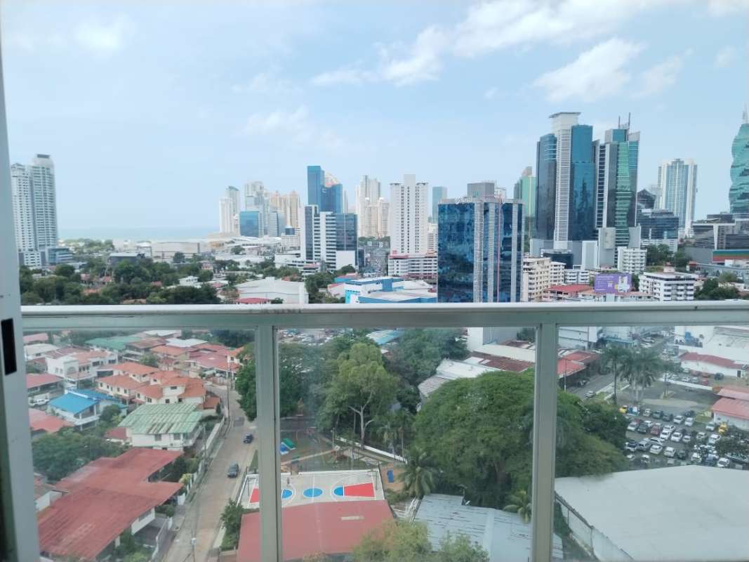 Highrise balcony glass railing with city skyline and ocean Panama at PH Oasis Tower Via Porras
