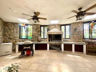 Bright bedroom with garden view large windows Punta Barco Village home Panama