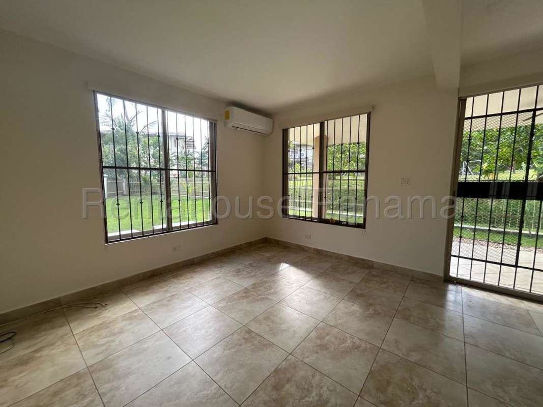 Kitchen with wooden cabinets, granite countertop, stainless appliances in Embassy Gardens Clayton Panama home