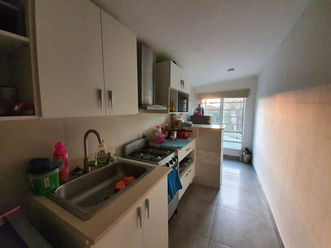 Galley style kitchen with window, white cabinetry, gas stove Balboa Ancón Canal Zone Panama