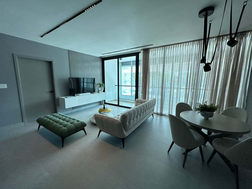 Sleek modern kitchen with island countertop, track lighting, cabinetry in PH Uptown Panama City