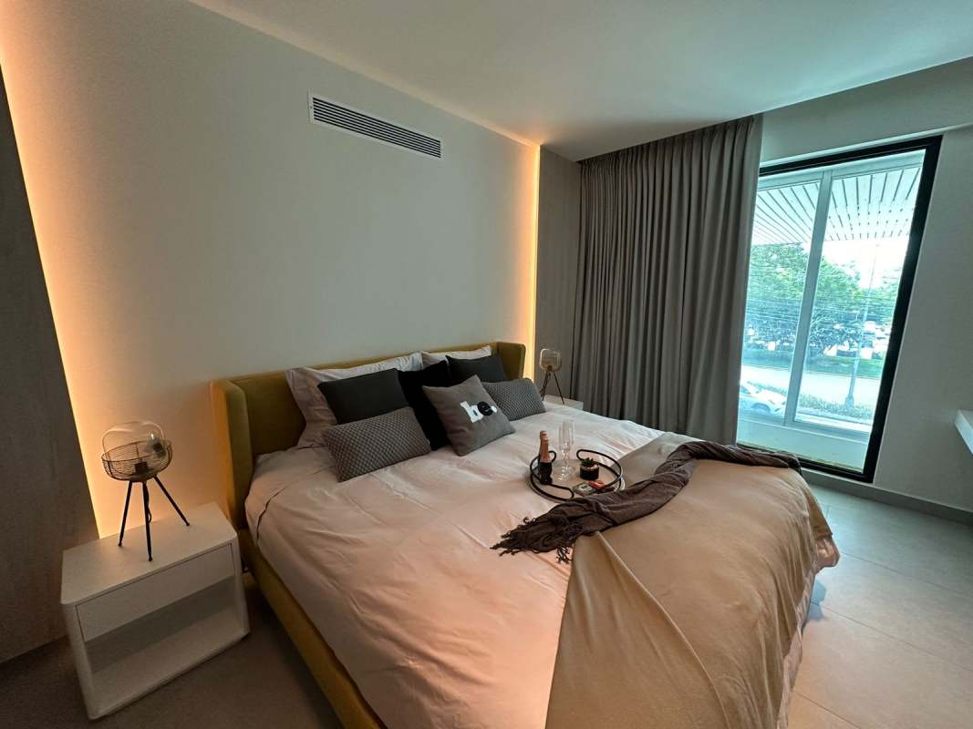 Minimalist bathroom with integrated sink, round mirror, glass shower in PH Uptown Calle Uruguay Panama