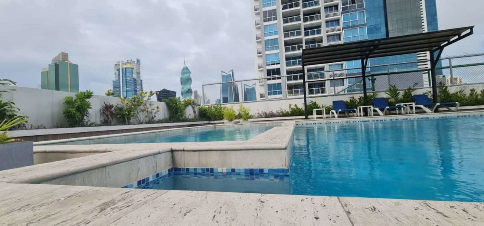 Modern kitchen with breakfast bar, white ceramic tile and microwave in PH Metric