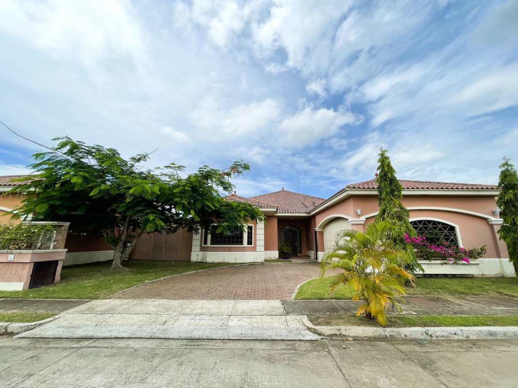 Exterior Mediterranean architecture luxury home in Costa Sur Panama with driveway and garden
