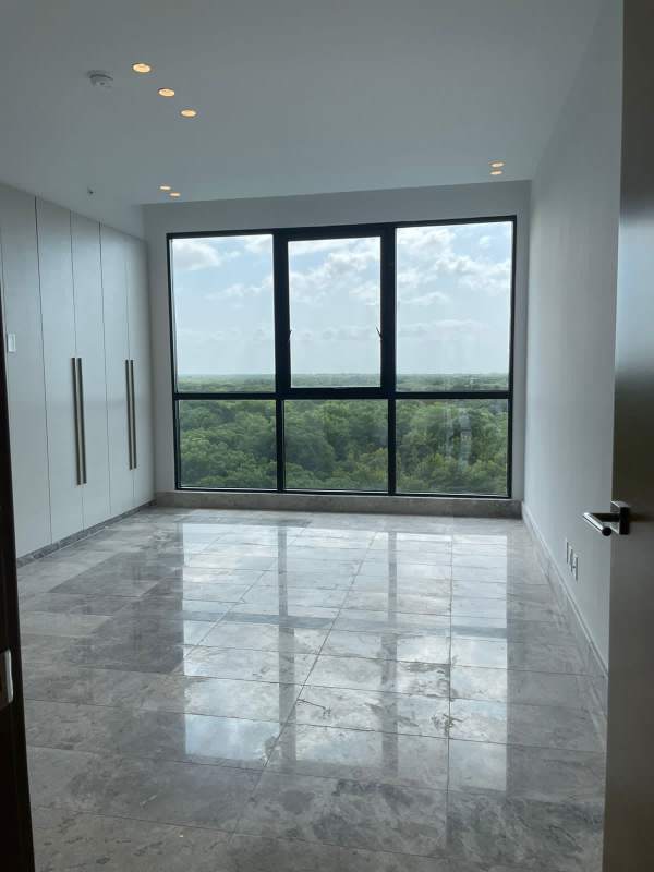 Bedroom with marble floors, large windows overlooking greenery in Empire Residences Santa Maria Panama