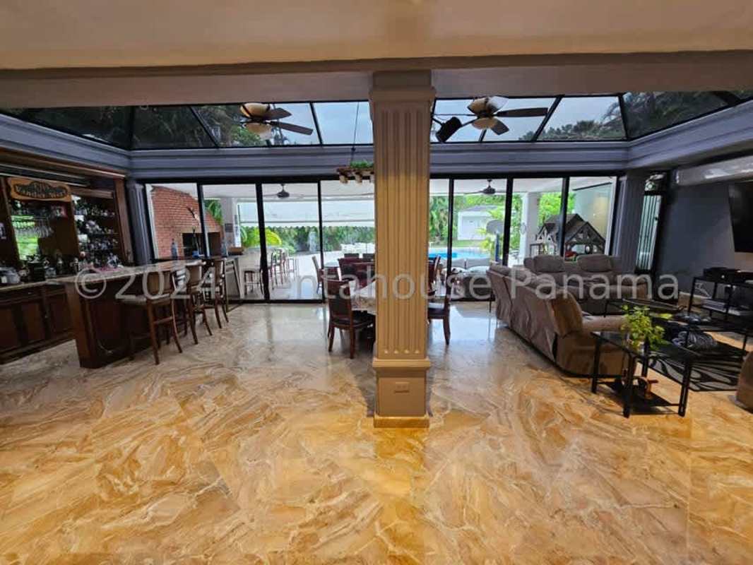 Sunroom enclosed patio with glass ceiling, dining space, bar, and garden views in Altos del Golf Panama City