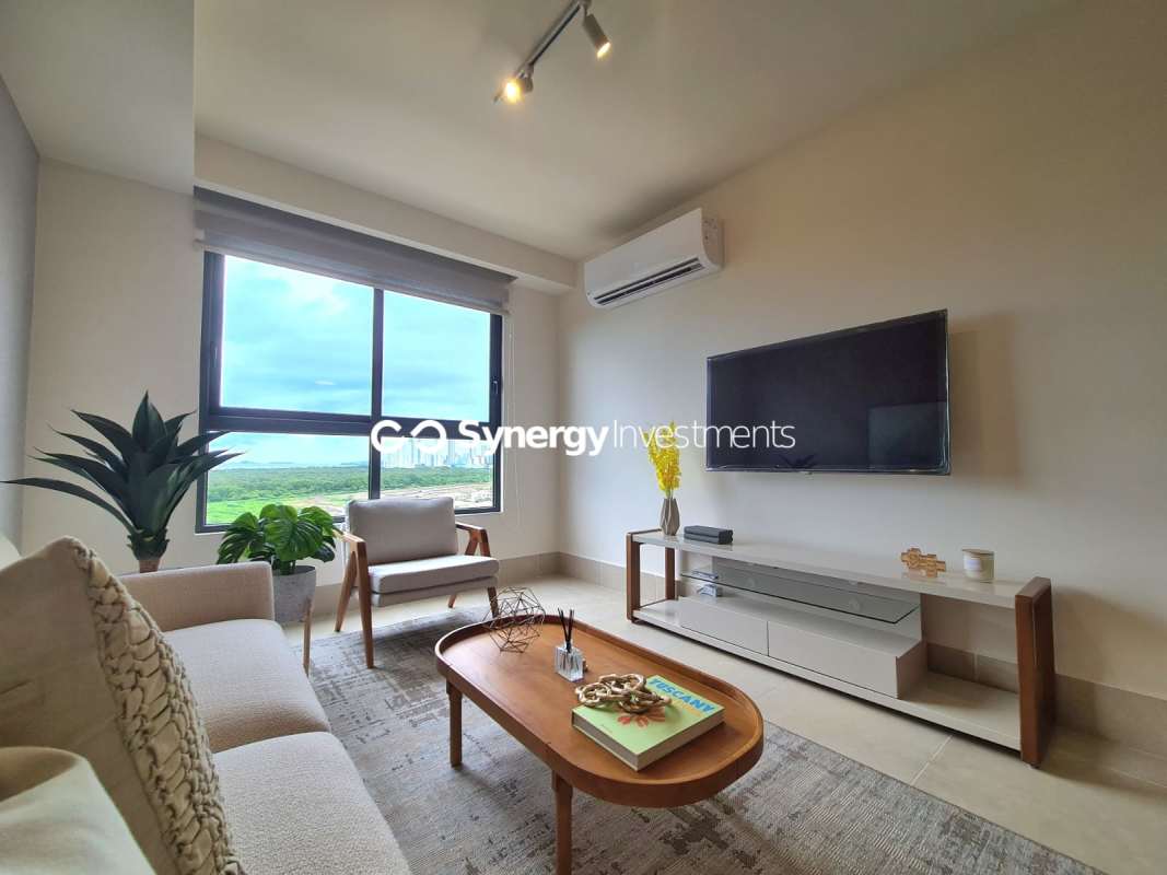 Contemporary kitchen with stainless appliances, dining space, and neutral decor inside Santa Maria Golf apartment Panama