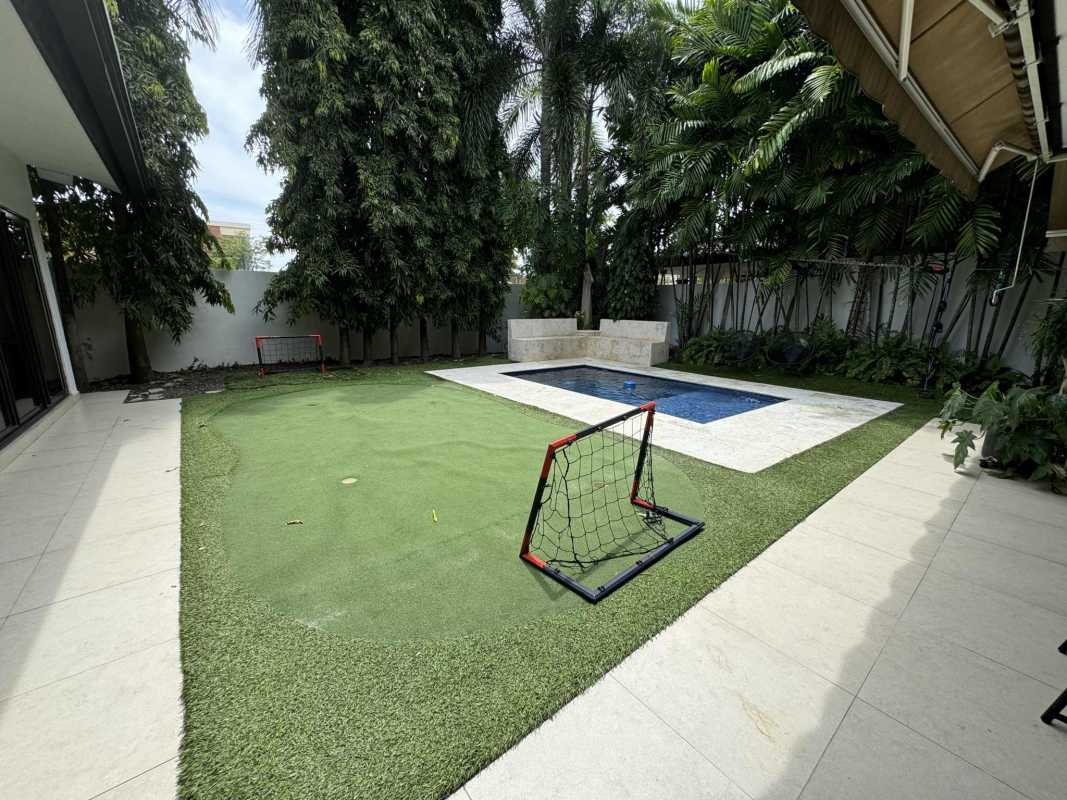 Sparkling swimming pool in backyard garden of luxury remodeled home PH Antigua Panama City