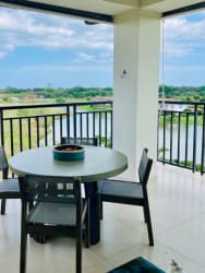 View of lagoon, white sand beach, and palm trees from penthouse in Buenaventura Panama