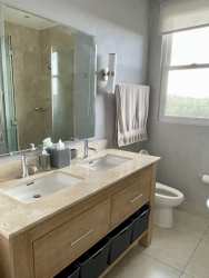 Luxury kitchen with stainless appliances, island and bright windows in penthouse Panama