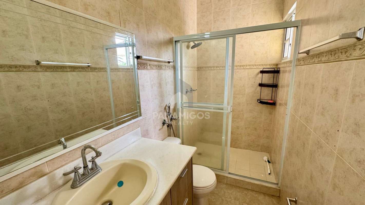 Traditional bathroom with beige tiles, glass shower and large mirror Palmeras del Este Costa del Este House