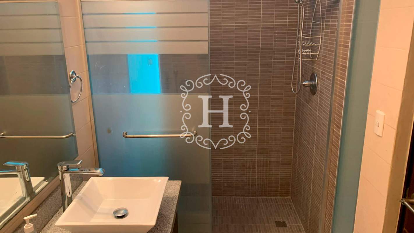 Modern loft bedroom with large windows and metal railing, El Cangrejo Panama City