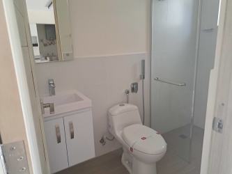 Sandy beach with lounge cabanas and palm trees at Punta Chame Beach Residences Panama