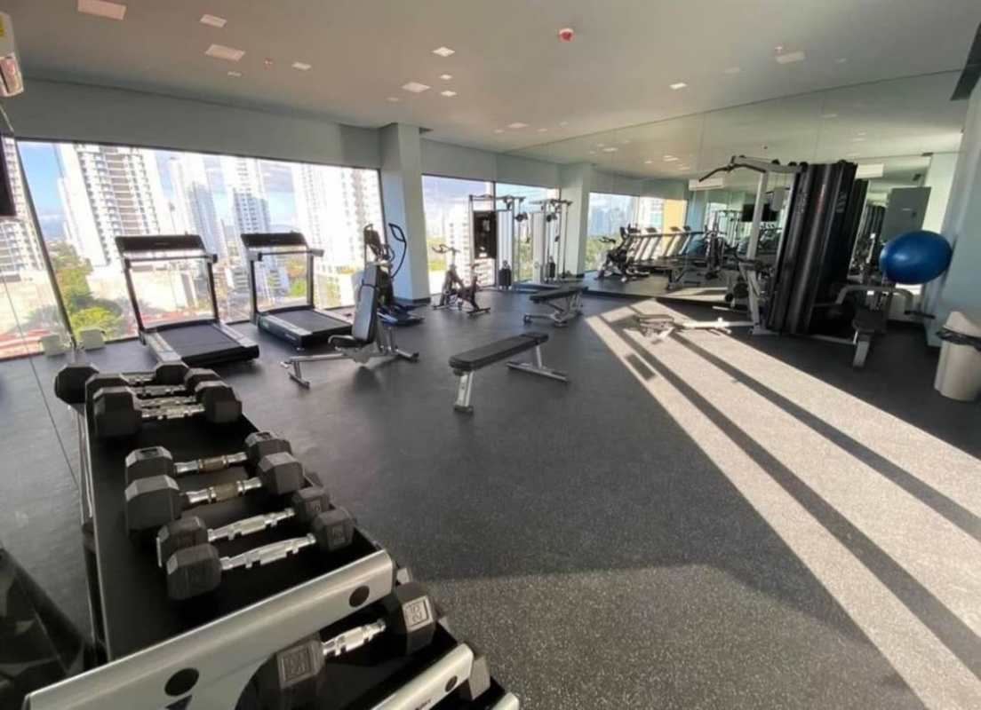 Modern building gym with equipment and skyline view in PH Coco del Mar Panama City for residents