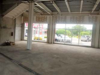 Modern retail office center with large glass storefronts and red accents in David Chiriquí Panama