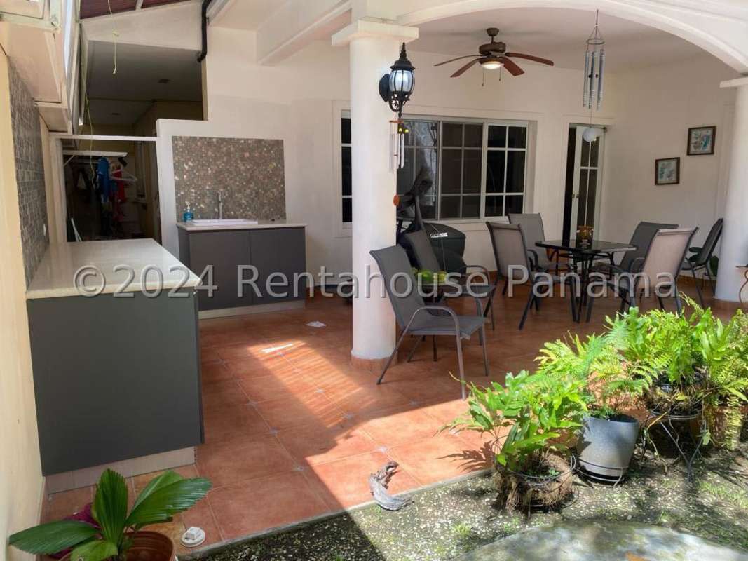 Covered terrace with lush tropical garden Costa del Este house Panama