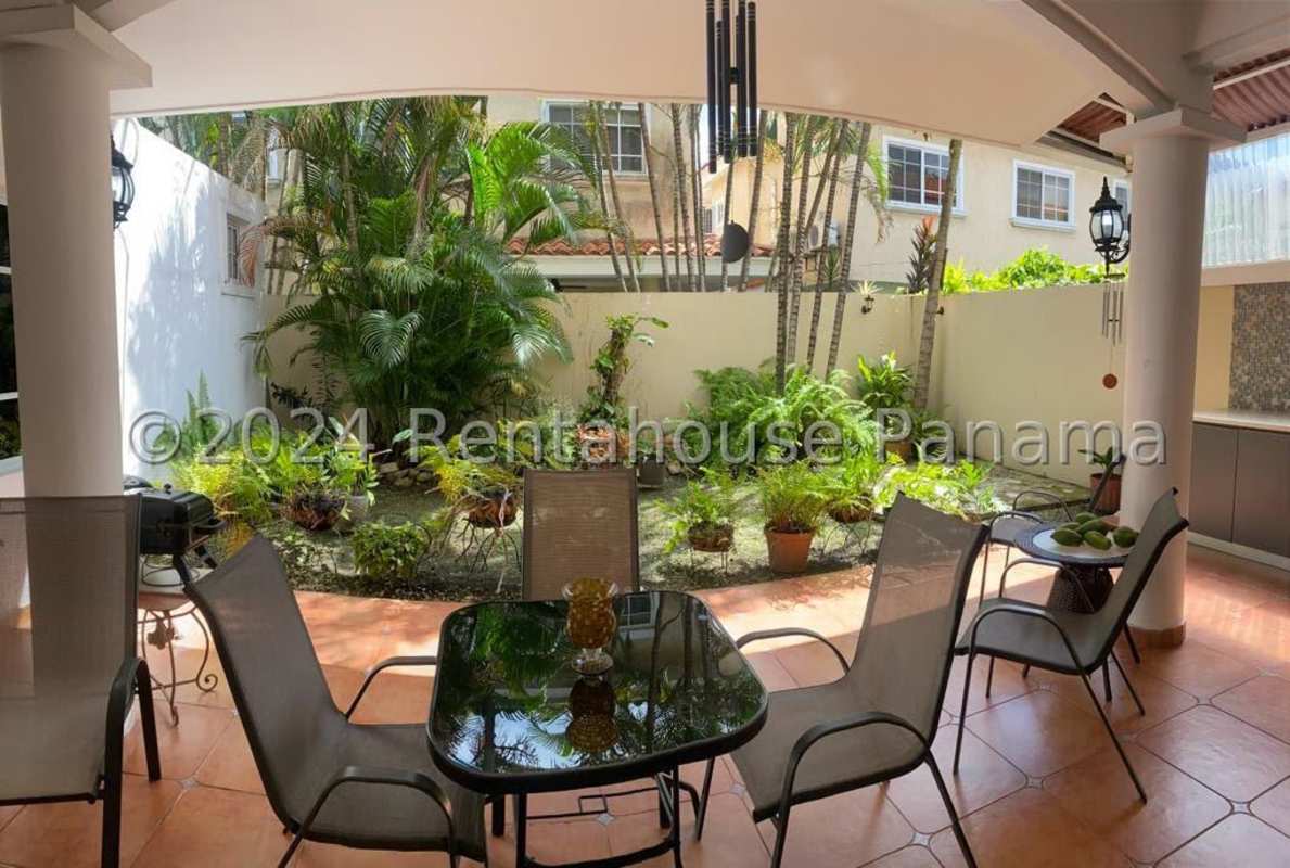 Covered patio seating overlooking tropical garden Costa del Este Panama house