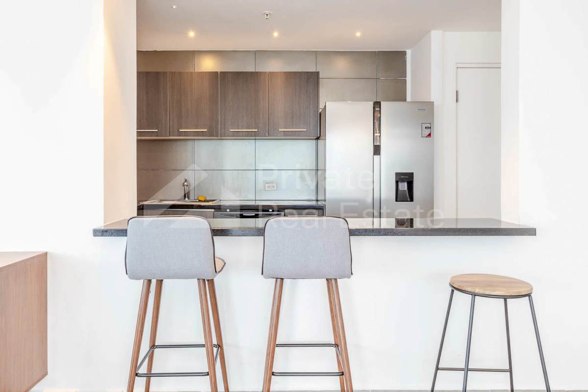 Bright living room with floor-to-ceiling windows overlooking the ocean at PH Yacht Club Torre Panama