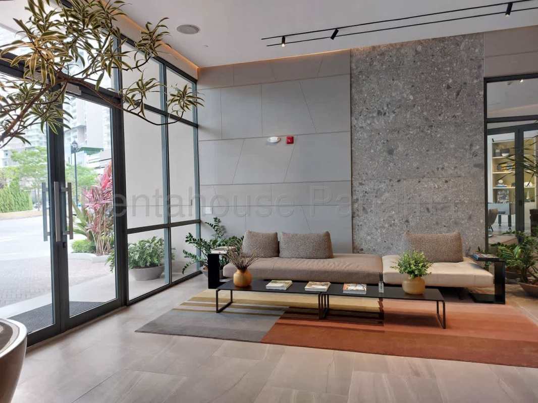 Modern lobby with lounge seating, indoor plants, large windows Ocean House Santa María